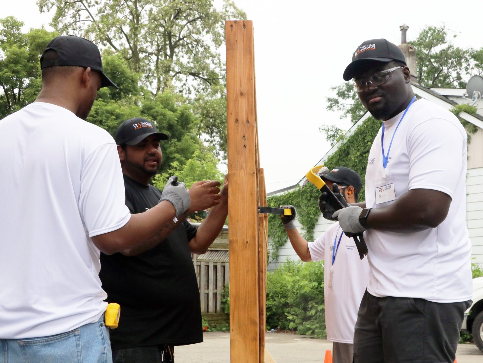 Reno Academy students collaborating on a fence post installation during hands-on trades training in Toronto
