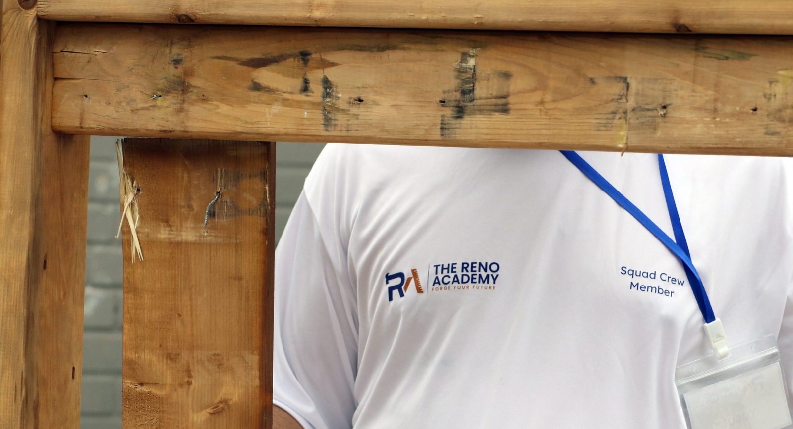 Reno Academy branded shirt and Squad Crew Member lanyard at a trades training site in Toronto