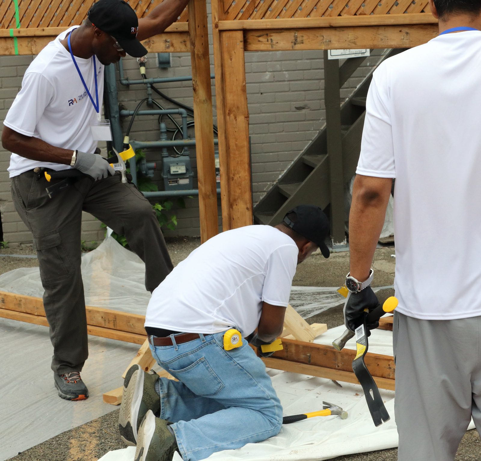 Reno Academy trainees setting up site protection with plastic sheeting during demolition practice in the GTA